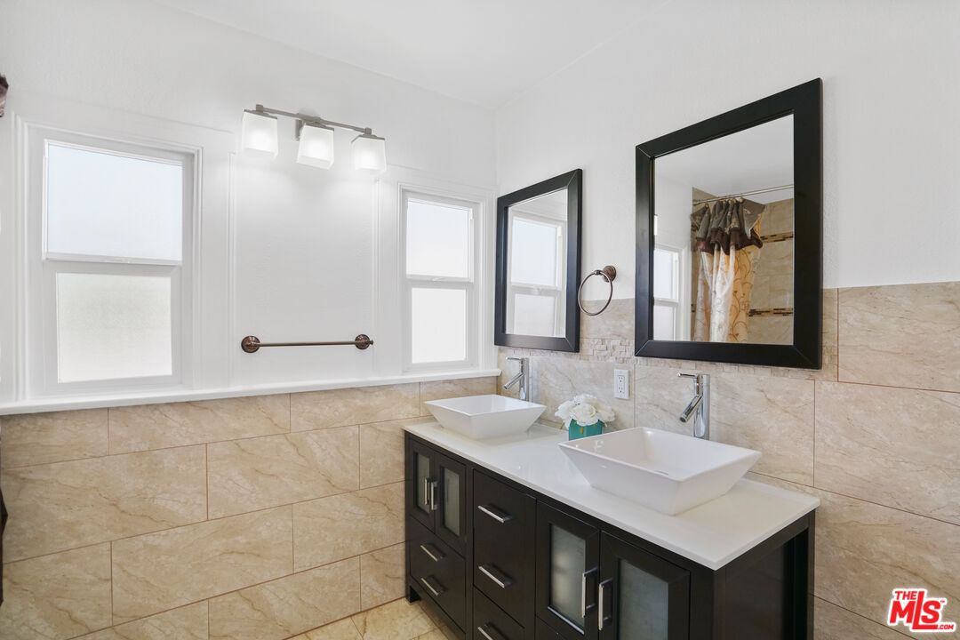 5133 Brynhurst Avenue View Park, CA 90043 - Photo 12 of 29 a bathroom with a sink vanity and a mirror