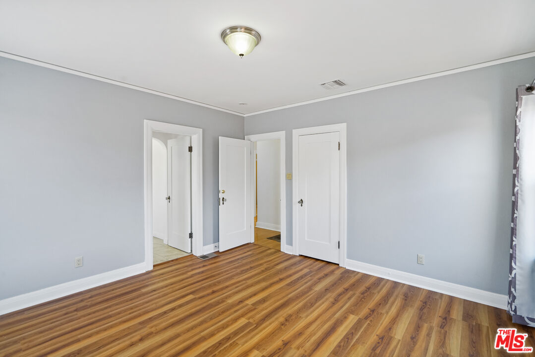 5133 Brynhurst Avenue View Park, CA 90043 - Photo 14 of 29 a view of empty room with wooden floor