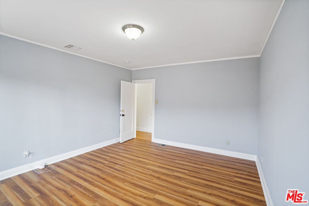 5133 Brynhurst Avenue View Park, CA 90043 - Photo 16 of 29 a view of a room with wooden floor