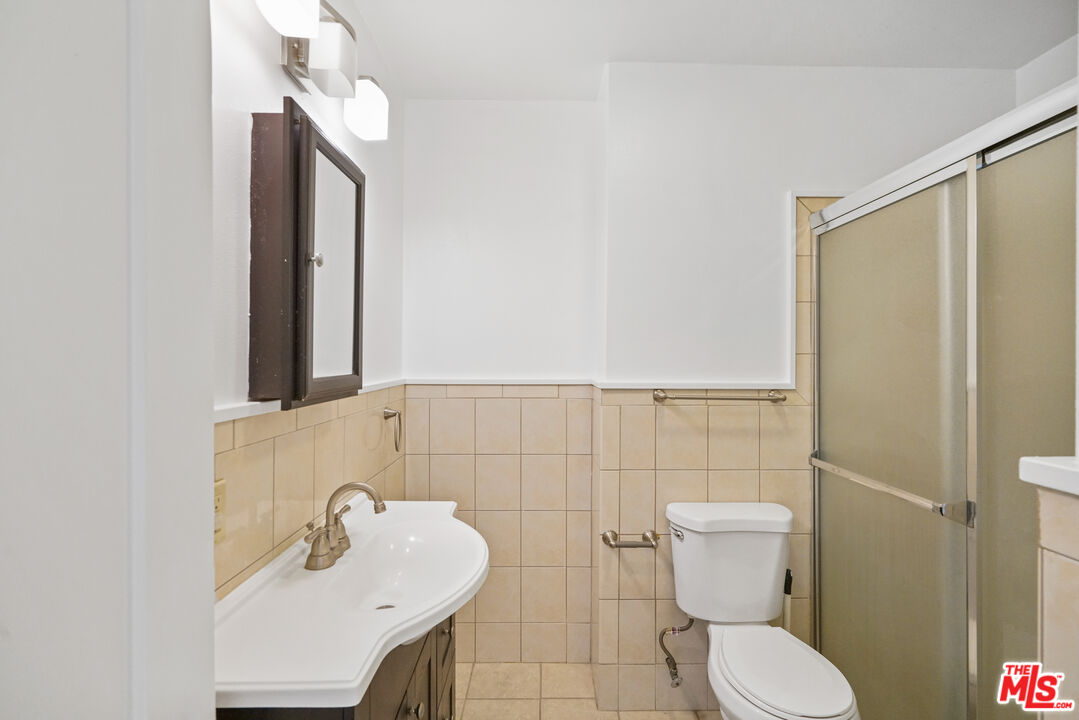 5133 Brynhurst Avenue View Park, CA 90043 - Photo 18 of 29 a bathroom with a sink toilet and shower