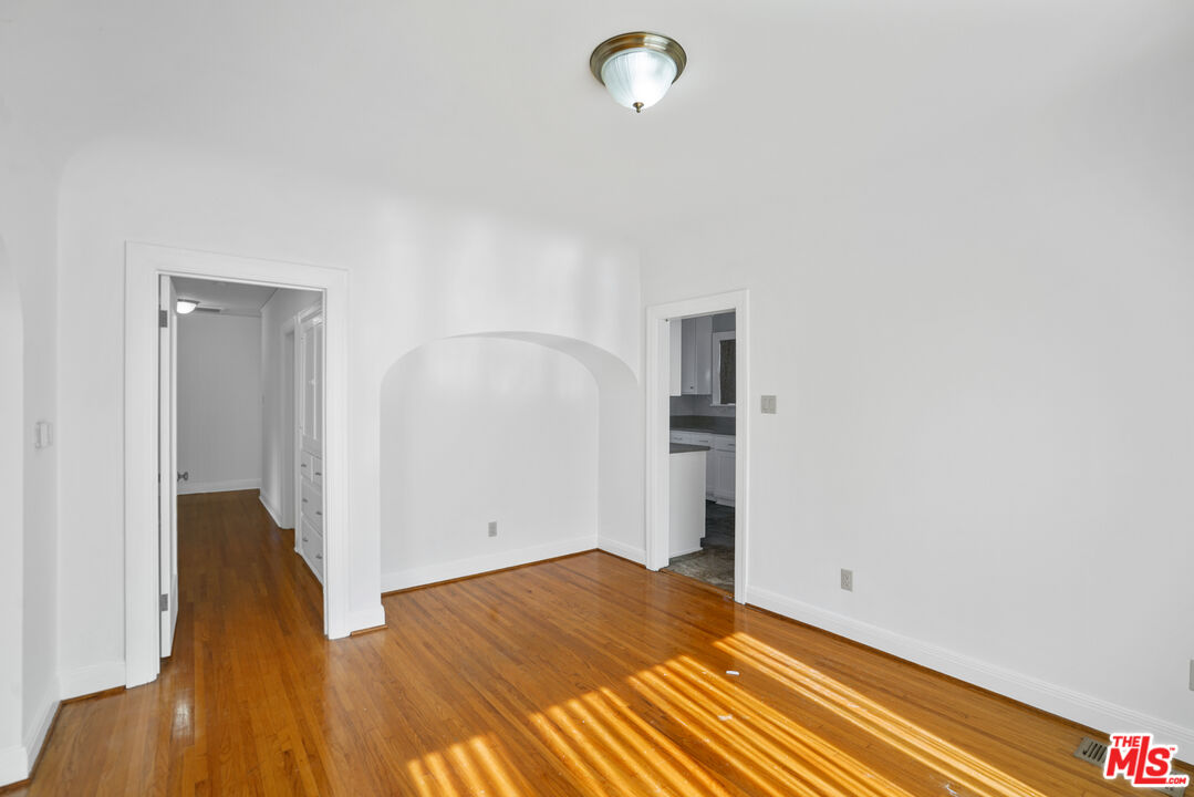 5133 Brynhurst Avenue View Park, CA 90043 - Photo 20 of 29 an empty room with wooden floor and entrance