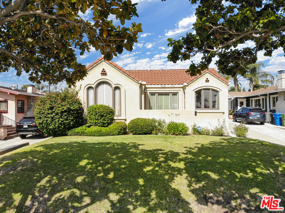 5133 Brynhurst Avenue View Park, CA 90043 - Photo 2 of 29 a front view of a house with a garden