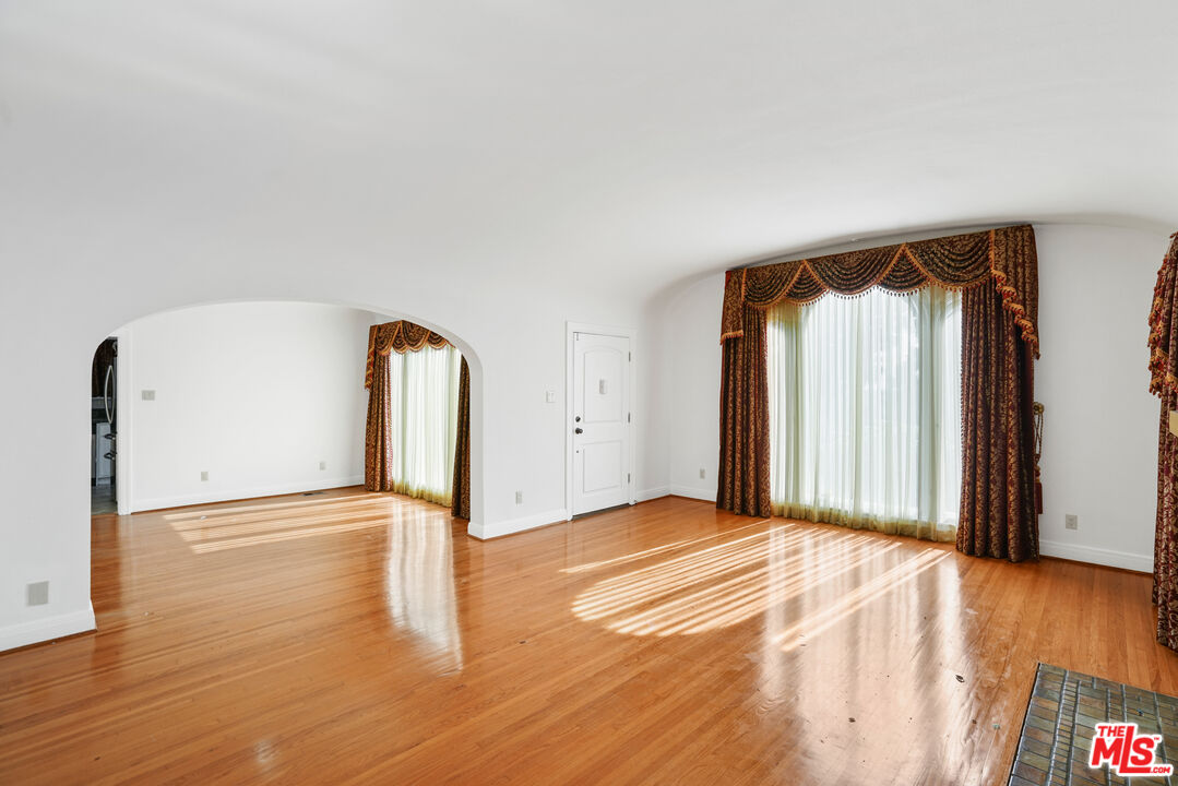 5133 Brynhurst Avenue View Park, CA 90043 - Photo 23 of 29 a view of an empty room with wooden floor and a window