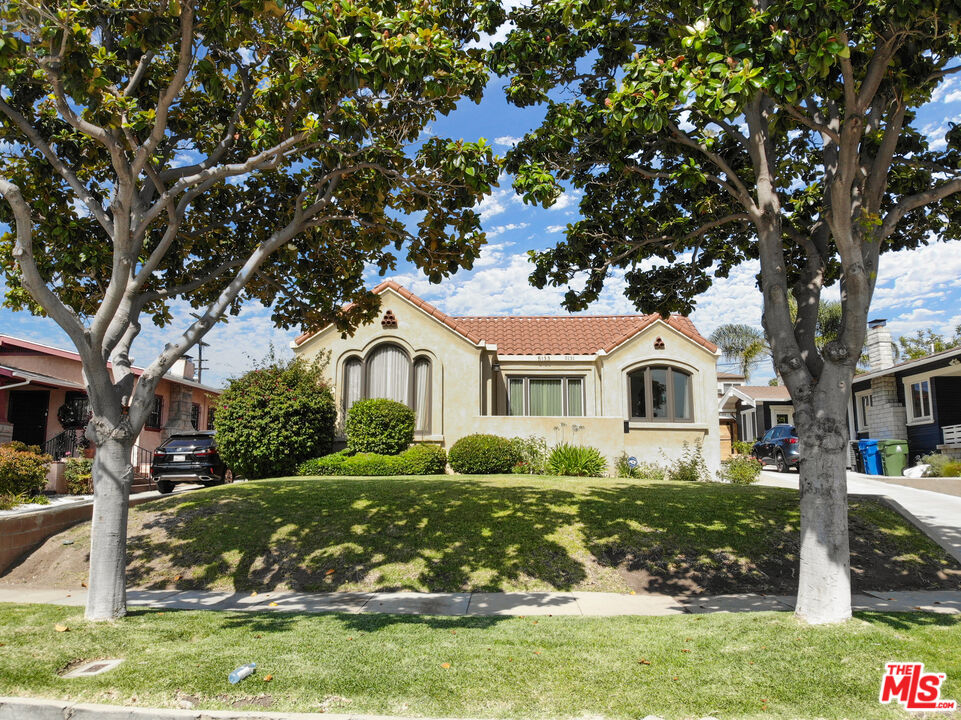 5133 Brynhurst Avenue View Park, CA 90043 - Photo 29 of 29 a front view of a house with garden