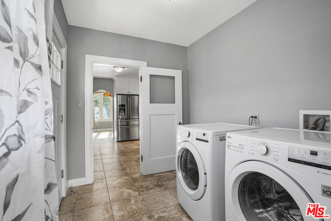 5133 Brynhurst Avenue View Park, CA 90043 - Photo 8 of 29 a view of a hallway with washer and dryer