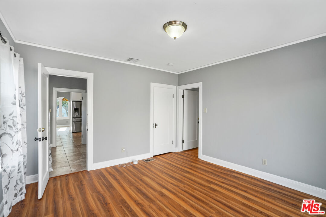 5133 Brynhurst Avenue View Park, CA 90043 - Photo 9 of 29 a view of a room with wooden floor and a bathroom