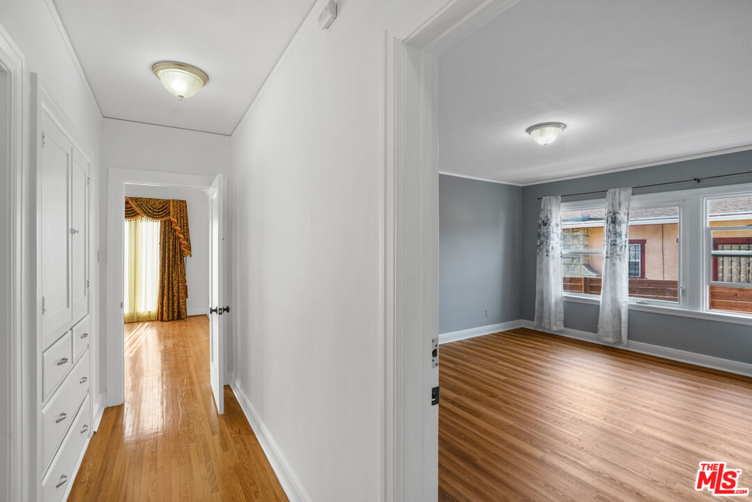 5133 Brynhurst Avenue View Park, CA 90043 - Photo 10 of 29 a view of hallway with wooden floor and stairs