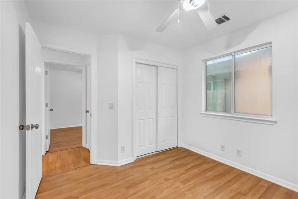 a view of hallway with wooden floor