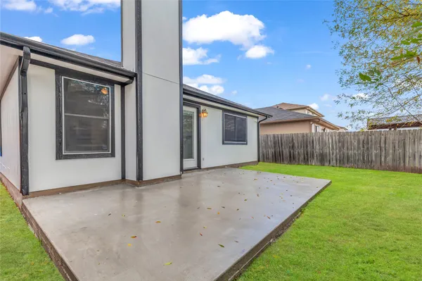 a backyard of a house with wooden fence