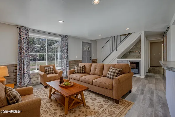 a living room with furniture a window and a table