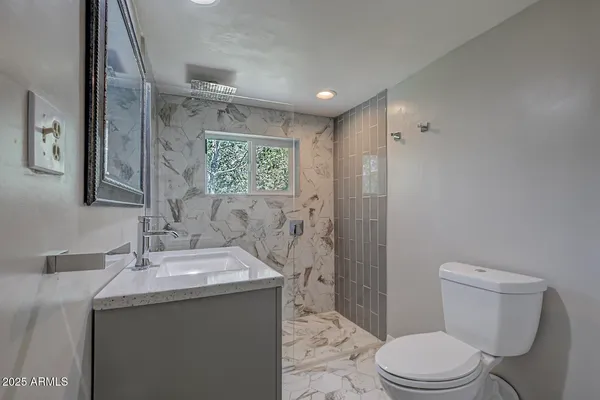 a bathroom with a toilet sink and shower