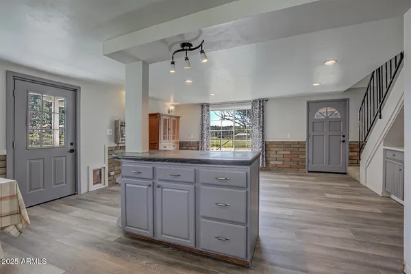 a spacious bathroom with a granite countertop sink a mirror and a shower