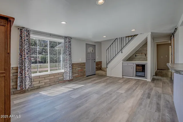 a spacious bathroom with a granite countertop sink a mirror and a shower