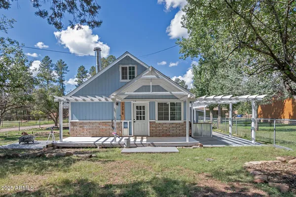a front view of a house with a yard table and chairs