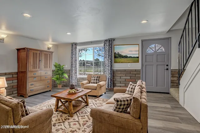a living room with furniture kitchen and a table