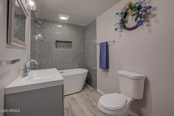 a bathroom with a sink a mirror a toilet and bathtub