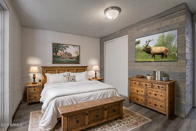 a spacious bedroom with a bed and a potted plant