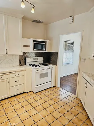 a kitchen with a stove a sink and a refrigerator