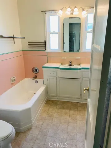 a bathroom with a bathtub and a sink