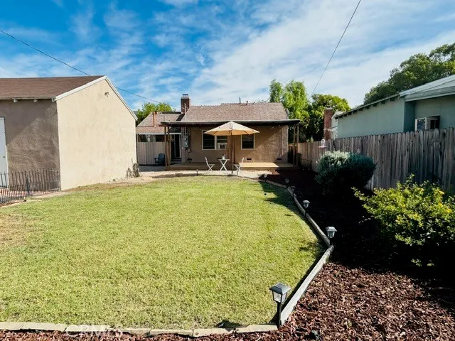 a swimming pool with yard in front of it