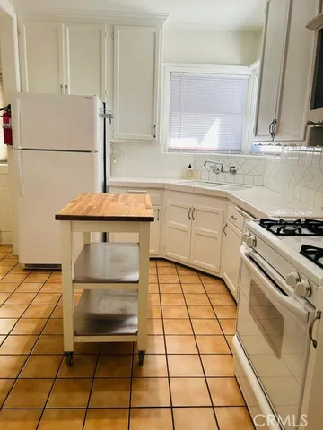 a kitchen with a sink cabinets and appliances