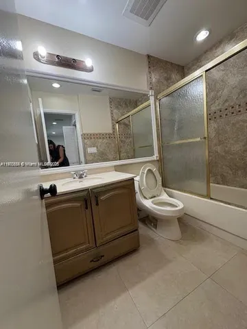 a bathroom with a toilet sink and shower