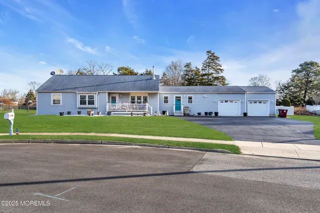 a aerial view of a house with a yard and potted plants