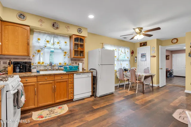 a kitchen with stainless steel appliances granite countertop a refrigerator and microwave