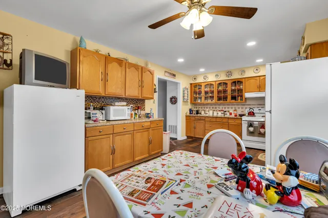 a kitchen that has a lot of cabinets and refrigerator