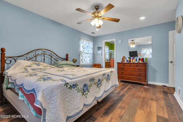 a spacious bedroom with a bed and a chandelier