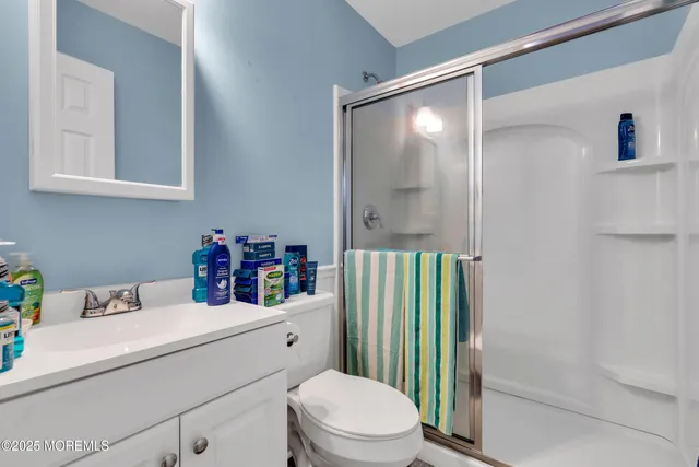 a bathroom with a sink vanity mirror and toilet