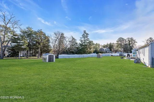 a black white and white photo of a small white house