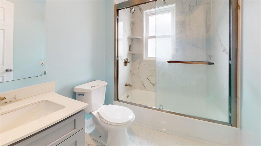 346 Cherry Street, Unit 2 Newton, MA 02465 - Photo 11 of 12 a bathroom with a sink a toilet and shower
