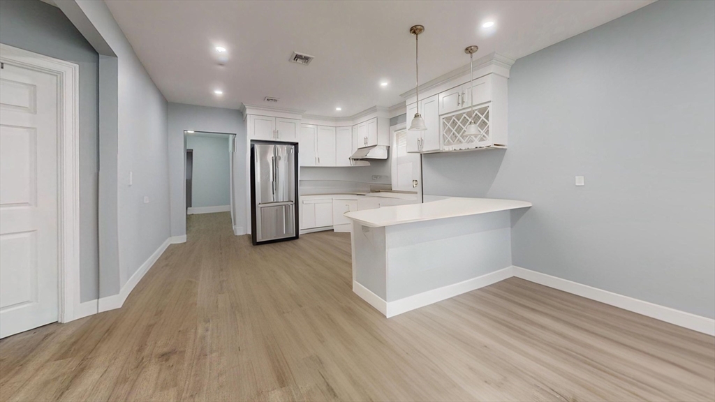 346 Cherry Street, Unit 2 Newton, MA 02465 - Photo 2 of 12 a view of a kitchen with refrigerator and wooden floor