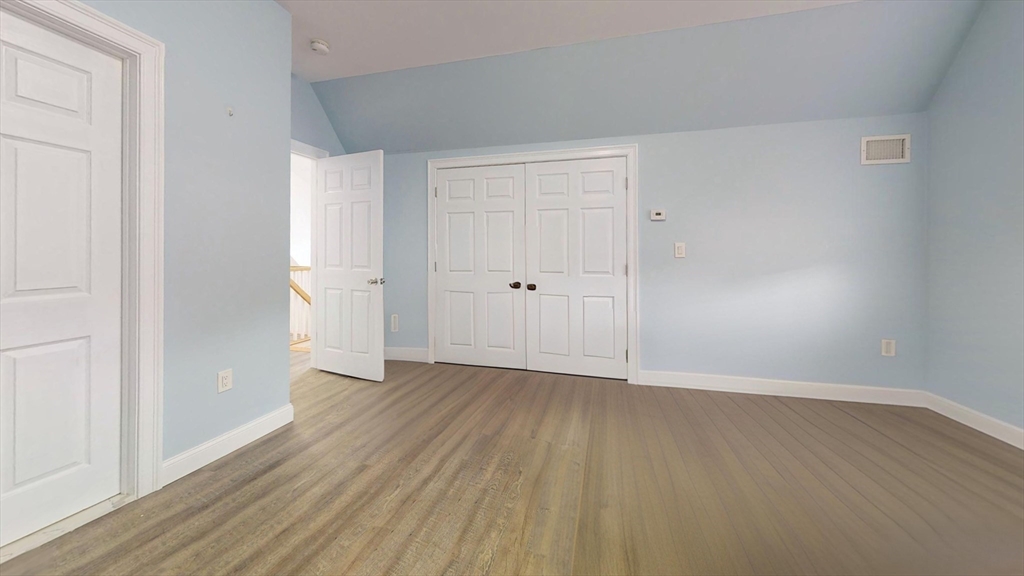 346 Cherry Street, Unit 2 Newton, MA 02465 - Photo 3 of 12 a view of an empty room with wooden floor