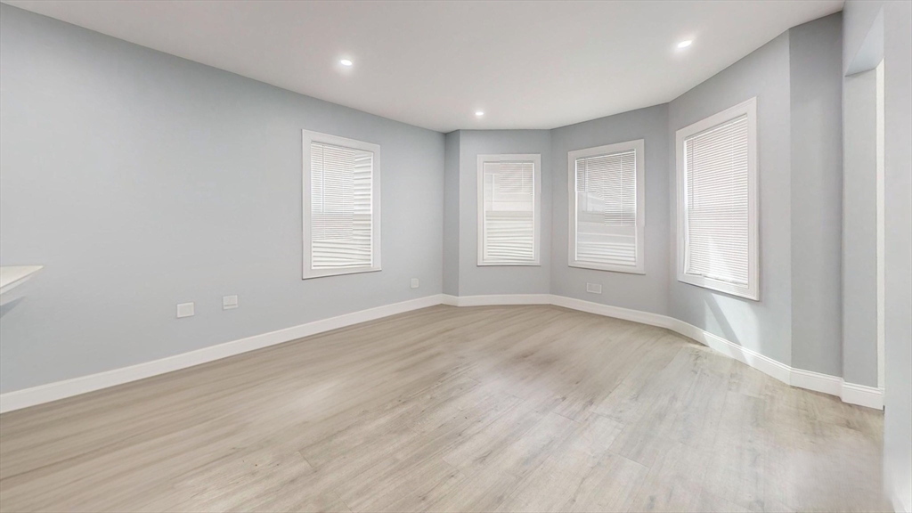 346 Cherry Street, Unit 2 Newton, MA 02465 - Photo 7 of 12 wooden floor in an empty room with a window