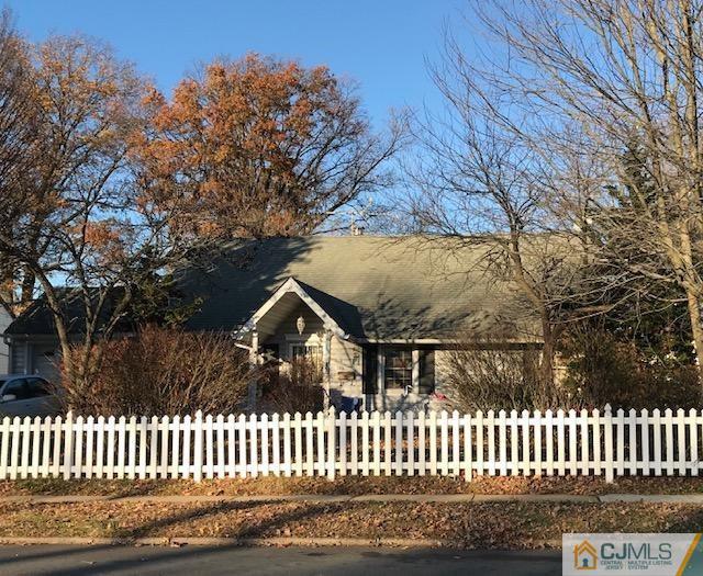106 Idlewild Road Edison, NJ 08817 - Photo 1 of 1 a view of a white house and a yard with wooden fence