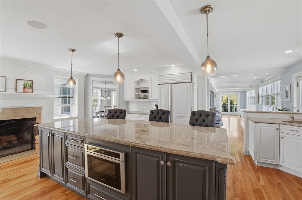 183 Whiting Street Hanover, MA 02339 - Photo 8 of 42 a kitchen with stainless steel appliances granite countertop a stove a sink a oven and a wooden floor