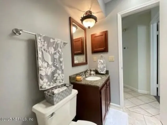 a bathroom with a sink toilet and mirror
