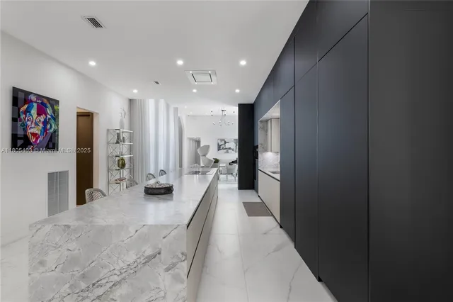 a living room with furniture kitchen view and a flat screen tv