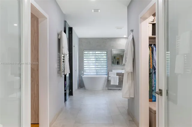 a bathroom with a white bath tub and a shower