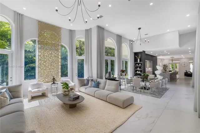 a living room with fireplace furniture and a large window