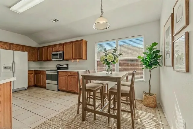 a kitchen with a table and chairs in it