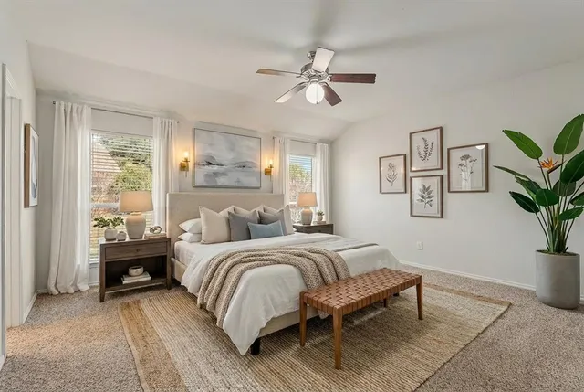 a bedroom with a bed and a potted plant