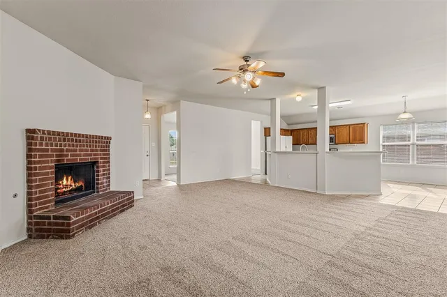 a view of a livingroom with wooden floor a fireplace