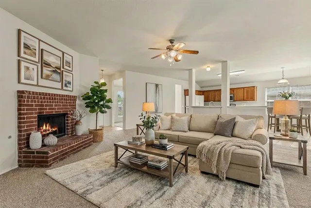 a living room with furniture a fireplace and a flat screen tv