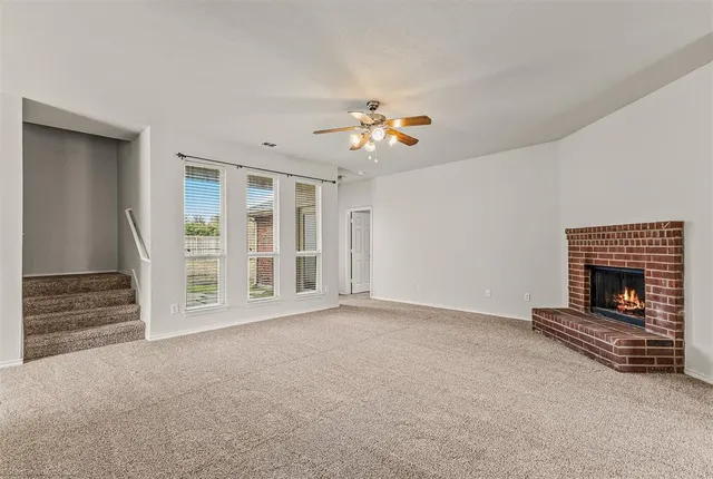a view of an empty room with a fireplace