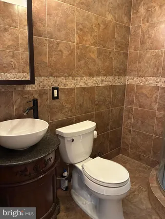 a picture of a bench in front of a wall