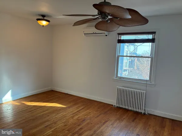 a bedroom with a bed a desk and chair with the bookshelf