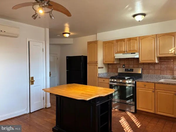 a kitchen with stainless steel appliances granite countertop a stove and a refrigerator